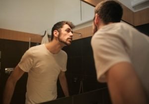 Bearded man looking at the mirror